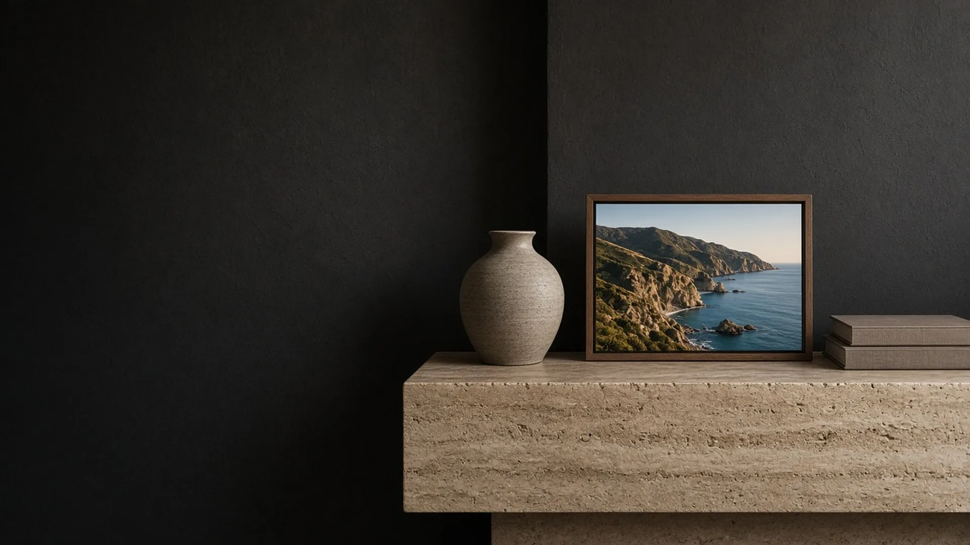 Digital frame showing a coastline on a travertine console