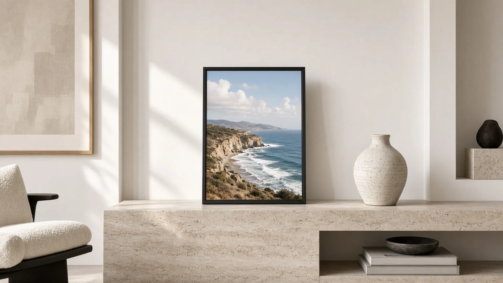 Digital frame showing a coastline photo on a travertine console